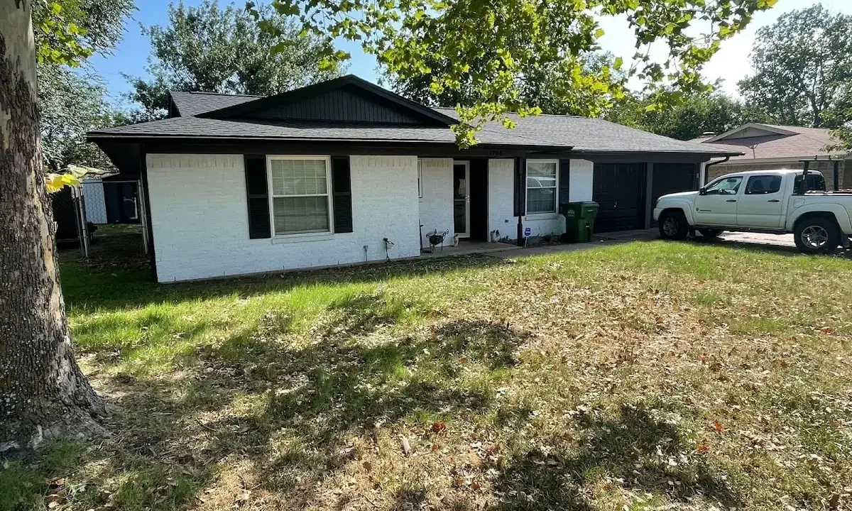 Professional roofing crew working on a residential roof in Corning